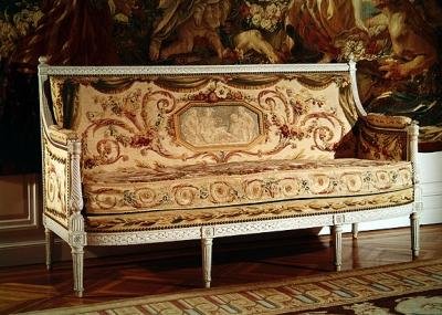 Carved wooden couch upholstered with tapestry, stamped Jacob by French School